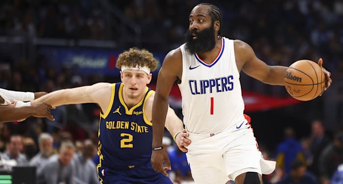 Los Angeles Clippers guard James Harden dribbles while Golden State Warriors guard Brandin Podziemski defends during a game on Dec. 14, 2023.